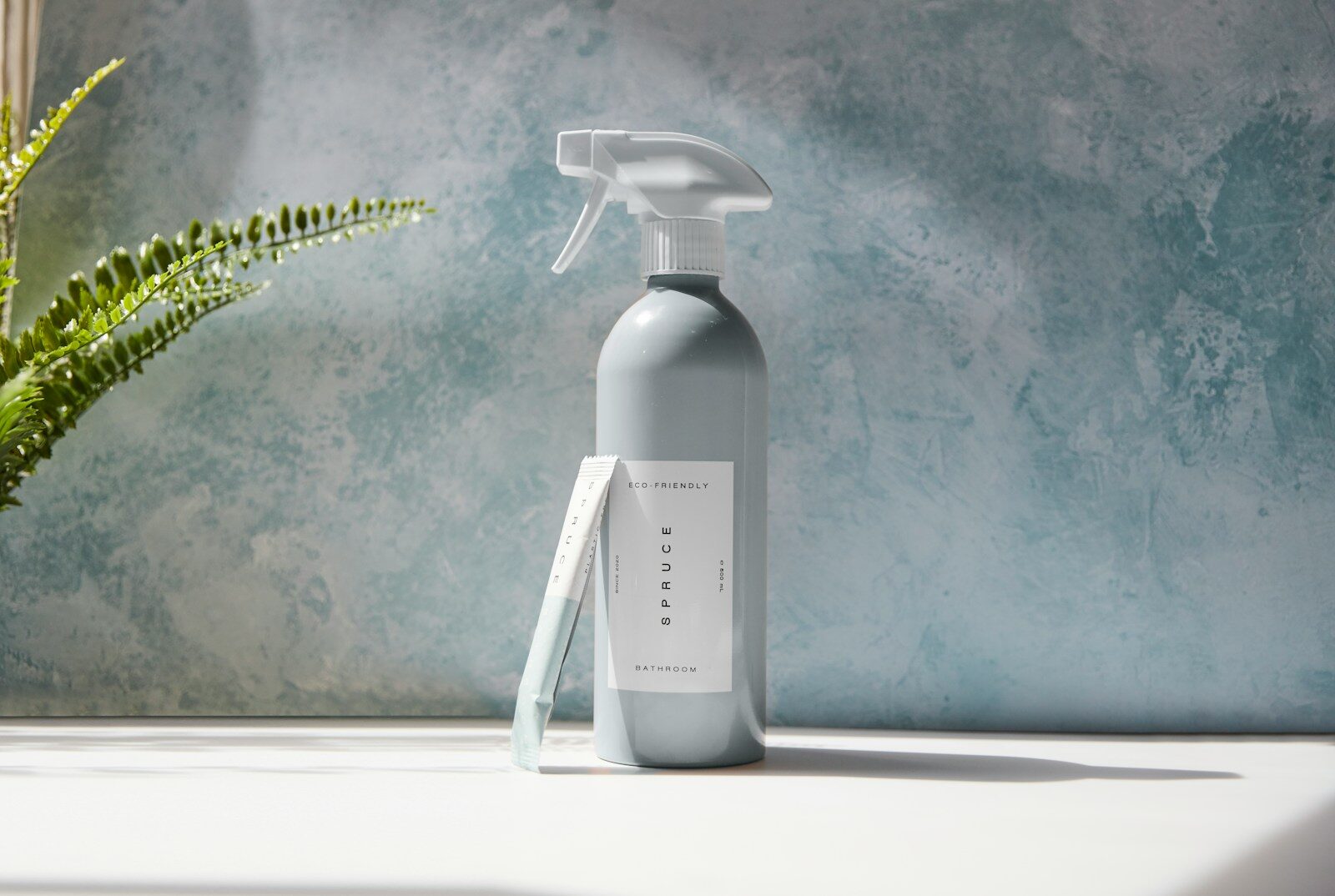 white plastic pump bottle on white table